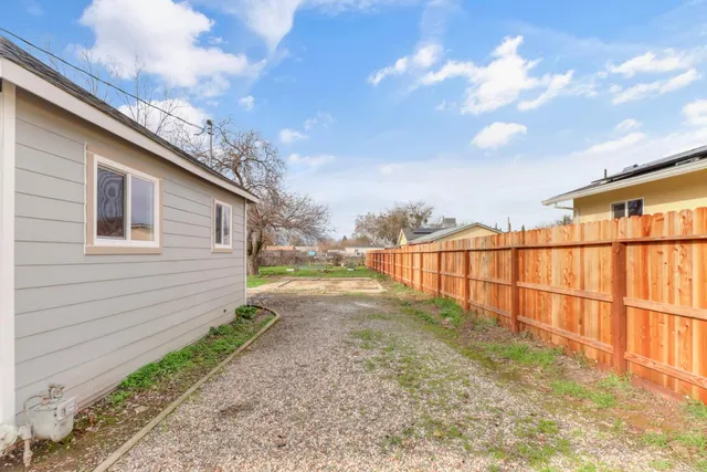 a view of a pathway of a house with wooden fence