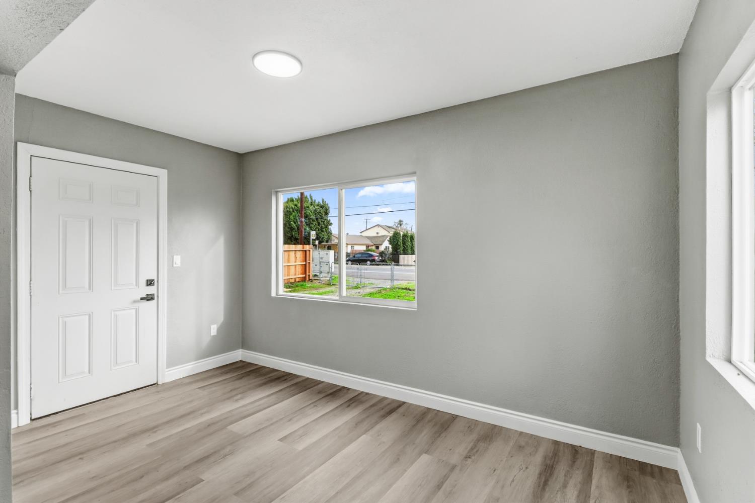 1099 Grand Avenue Olivehurst, CA 95961 - Photo 4 of 38 an empty room with wooden floor and windows