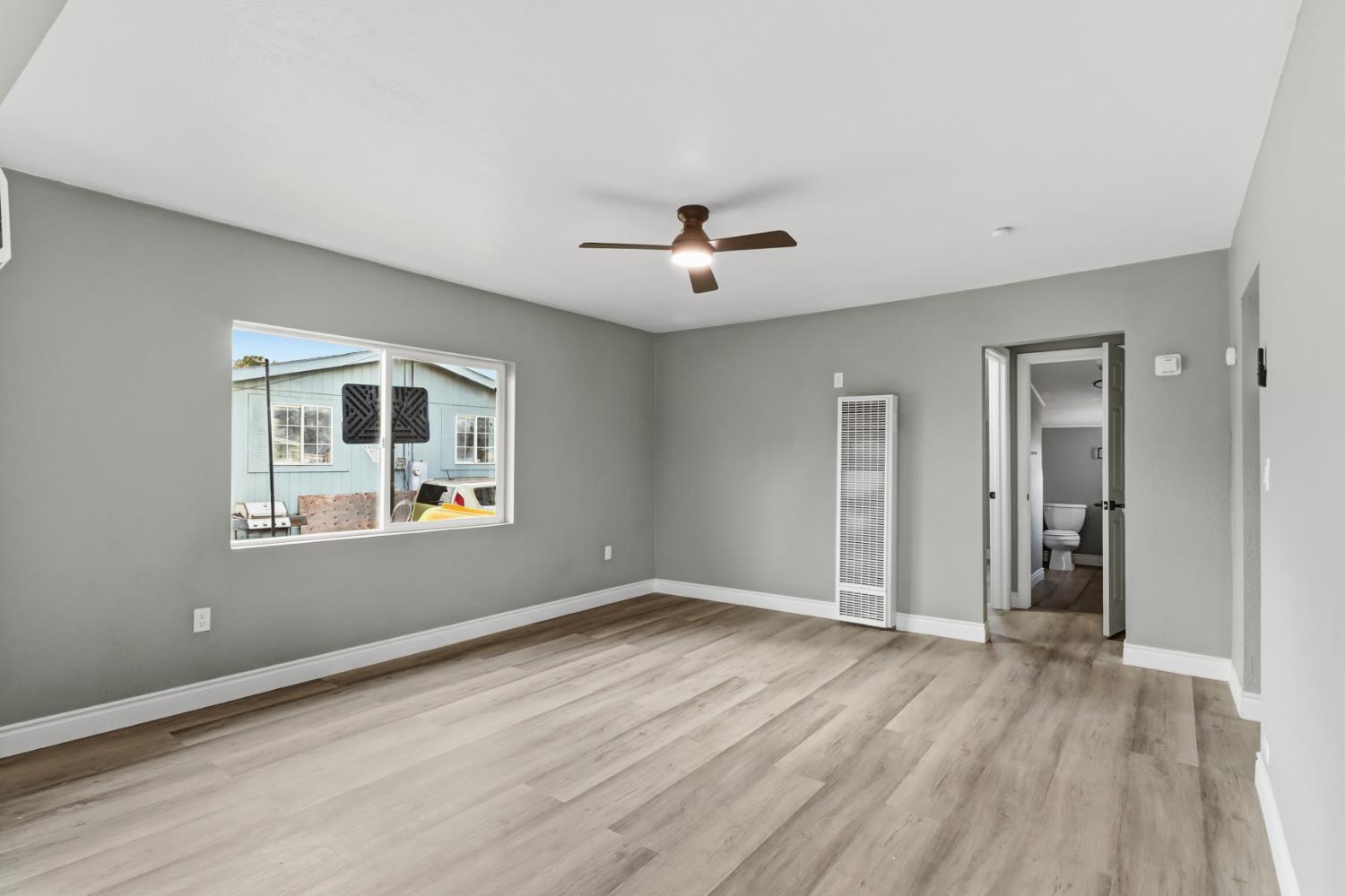 1099 Grand Avenue Olivehurst, CA 95961 - Photo 6 of 38 wooden floor in an empty room with a window