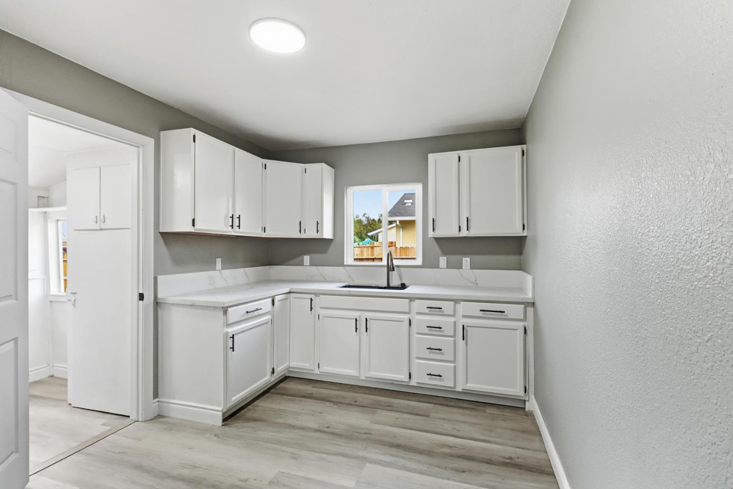 1099 Grand Avenue Olivehurst, CA 95961 - Photo 10 of 38 a kitchen with white cabinets stainless steel appliances and sink
