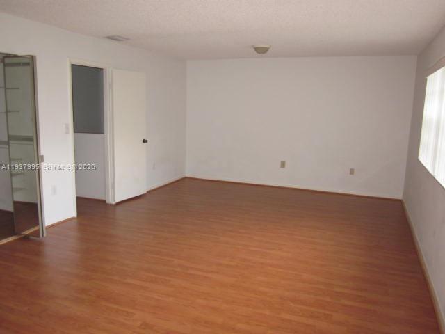 13224 Southwest 10th Terrace Miami, FL 33184 - Photo 13 of 32 an empty room with wooden floor and windows
