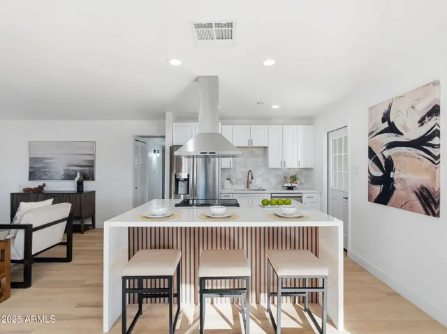 a living room with furniture and view of kitchen