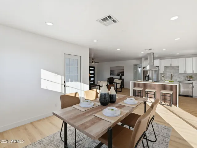 a dining room with furniture and wooden floor