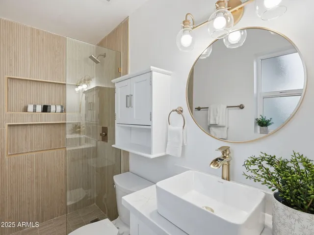 a kitchen with a refrigerator and white cabinets