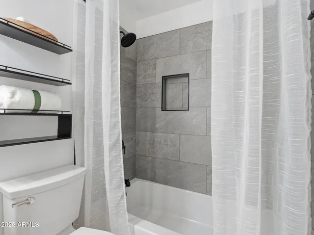 a bathroom with a sink vanity and toilet