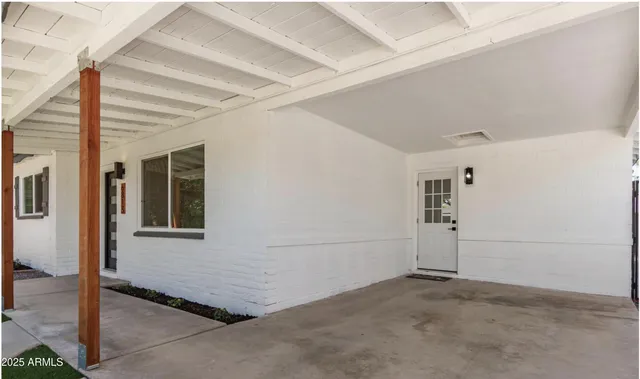 a backyard of a house with table and chairs