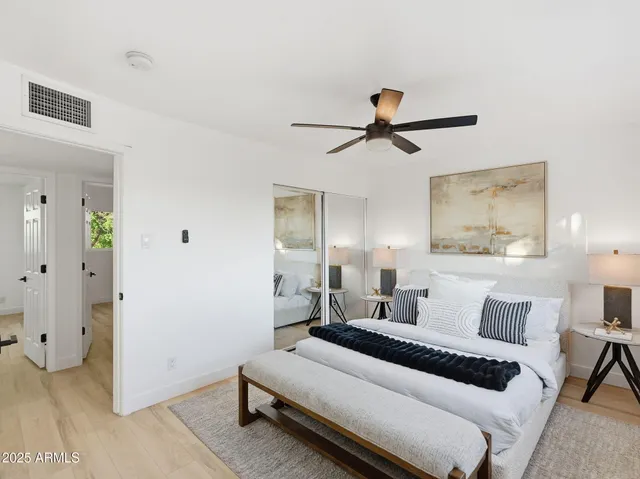 a bedroom with a bed and wooden floor