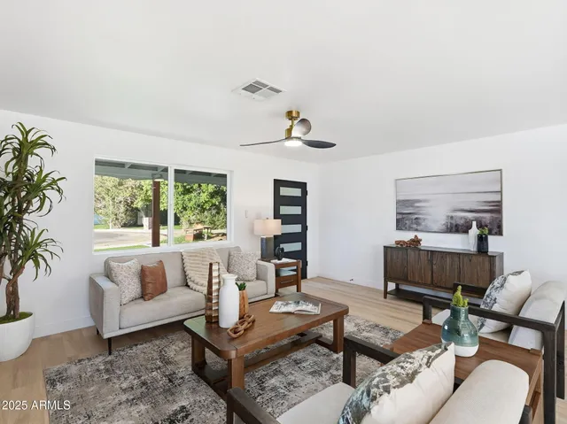 a kitchen with stainless steel appliances a refrigerator a sink dishwasher and a stove with wooden floor