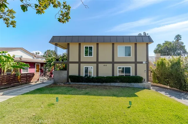 a front view of a house with a yard