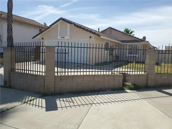 a view of balcony with a white wall and wooden fence