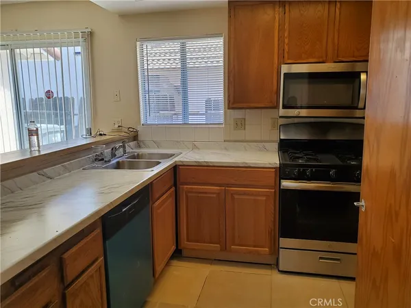 a kitchen with a sink stove and microwave