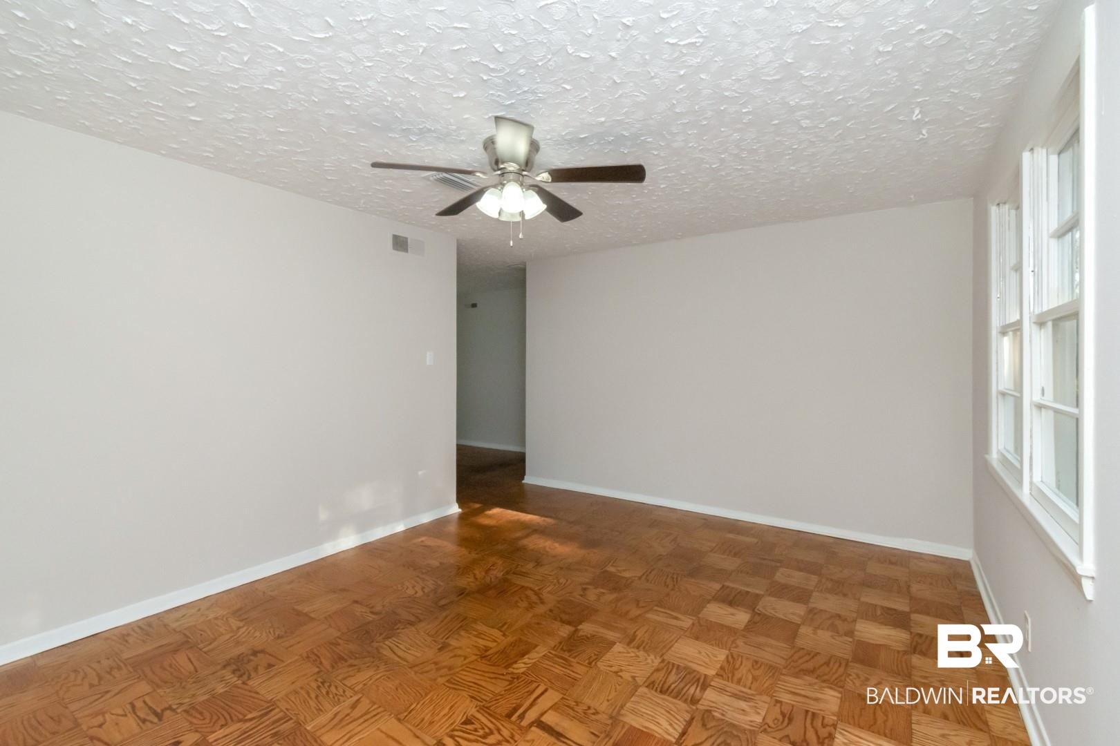 1220 Garland Drive Mobile, AL 36618 - Photo 5 of 25 Spare room with ceiling fan, parquet floors, and a textured ceiling