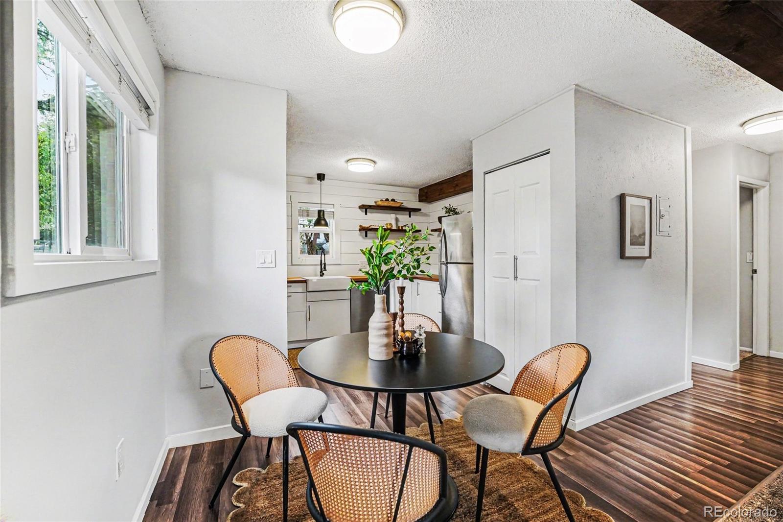 5700 West 28th Avenue, Unit 1 Wheat Ridge, CO 80214 - Photo 7 of 25 a view of a dining room with furniture and wooden floor