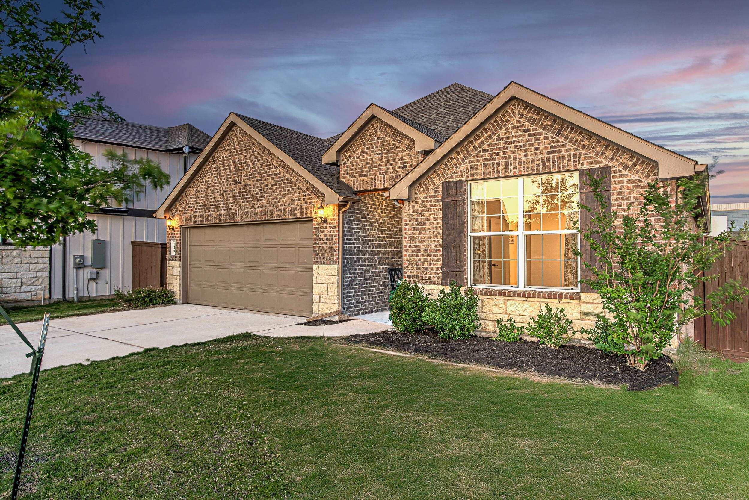 a front view of a house with a yard and garage