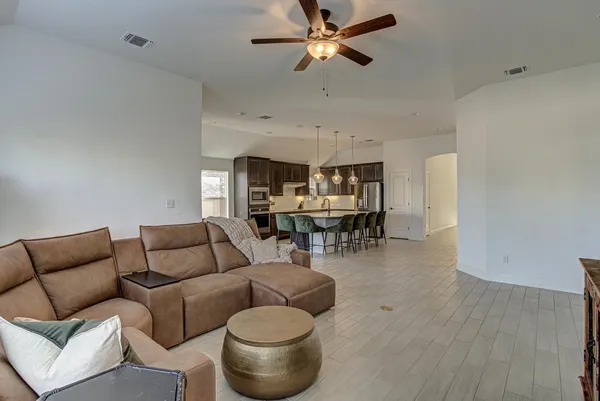 a living room with furniture and a wooden floor