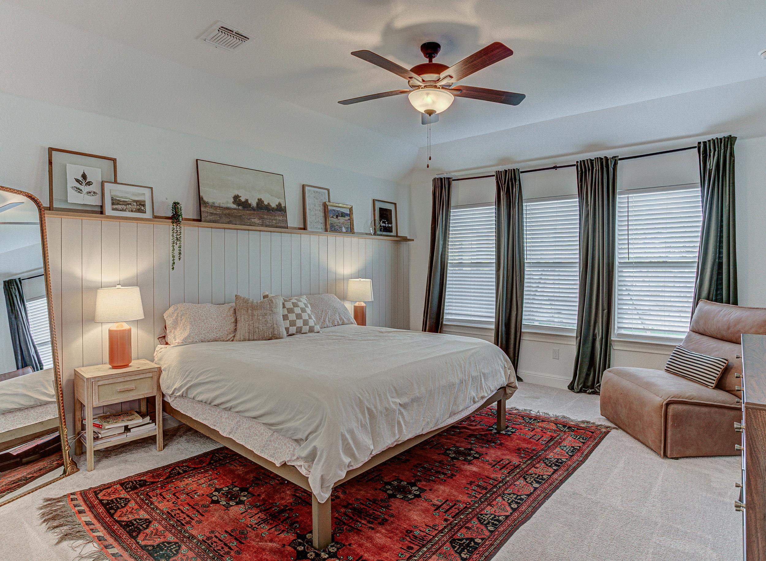 149 Slenderleaf Drive Marble Falls, TX 78654 - Photo 13 of 30 a bedroom with a large bed a couch and a chandelier