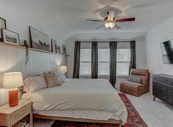 a bedroom with a bed and a flat screen tv