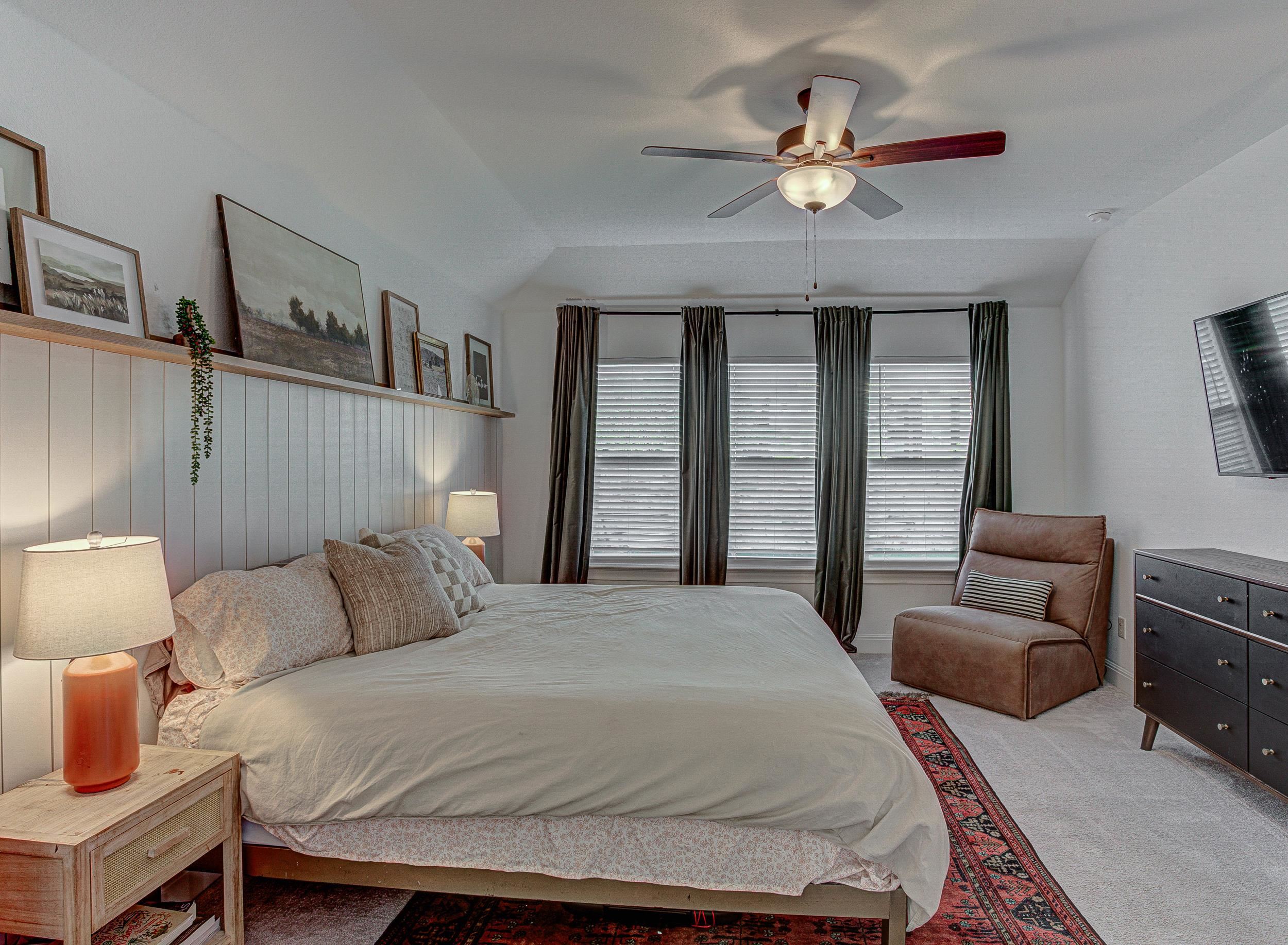 149 Slenderleaf Drive Marble Falls, TX 78654 - Photo 14 of 30 a bedroom with a bed a couch and a ceiling fan