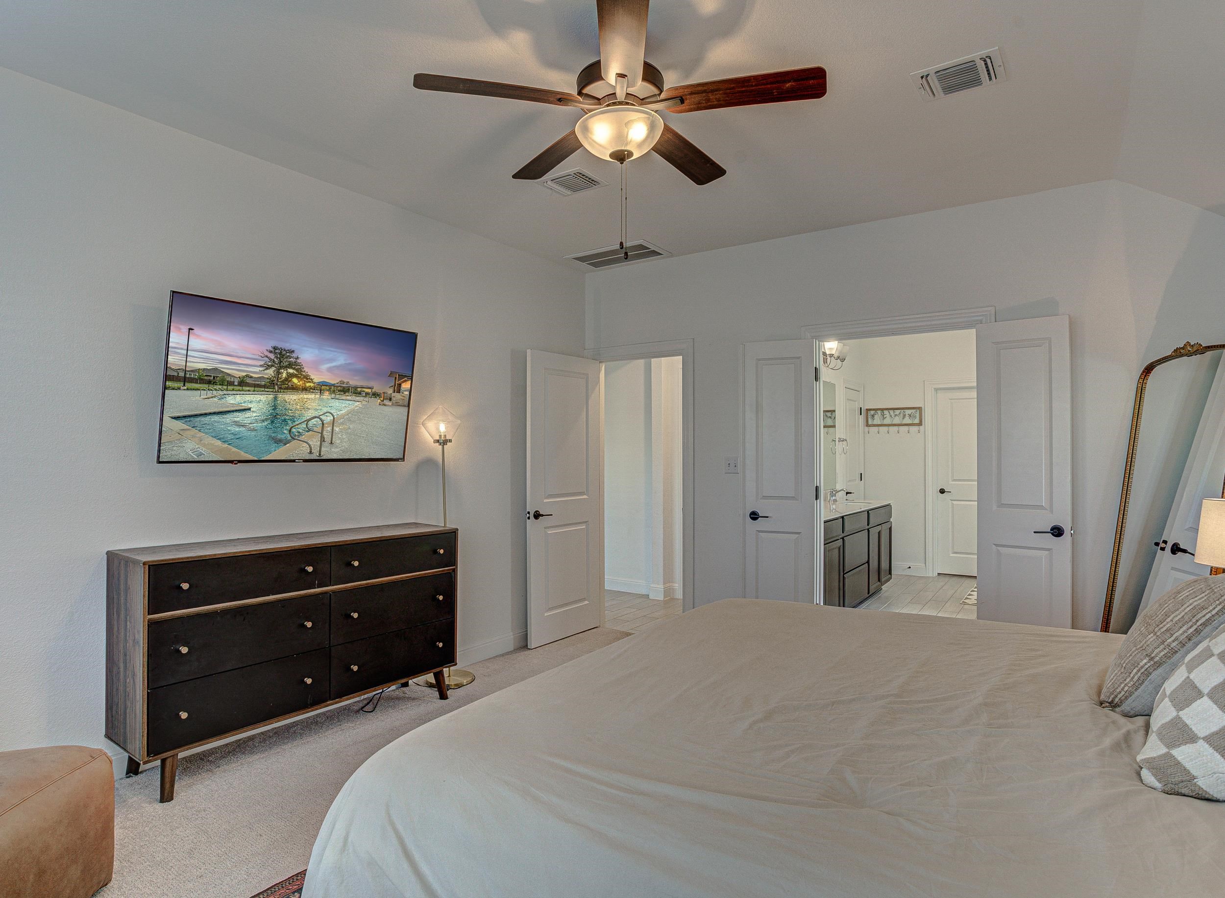 149 Slenderleaf Drive Marble Falls, TX 78654 - Photo 15 of 30 a bedroom with a bed and a flat screen tv