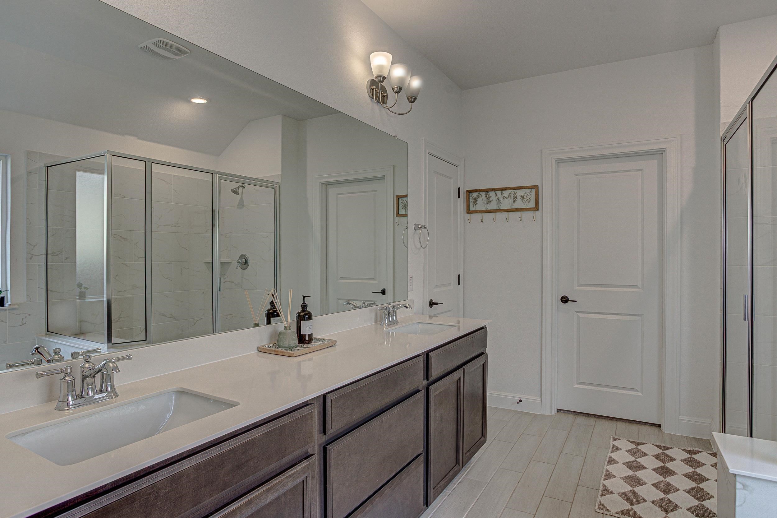 149 Slenderleaf Drive Marble Falls, TX 78654 - Photo 17 of 30 a bathroom with double vanity sinks and a mirror