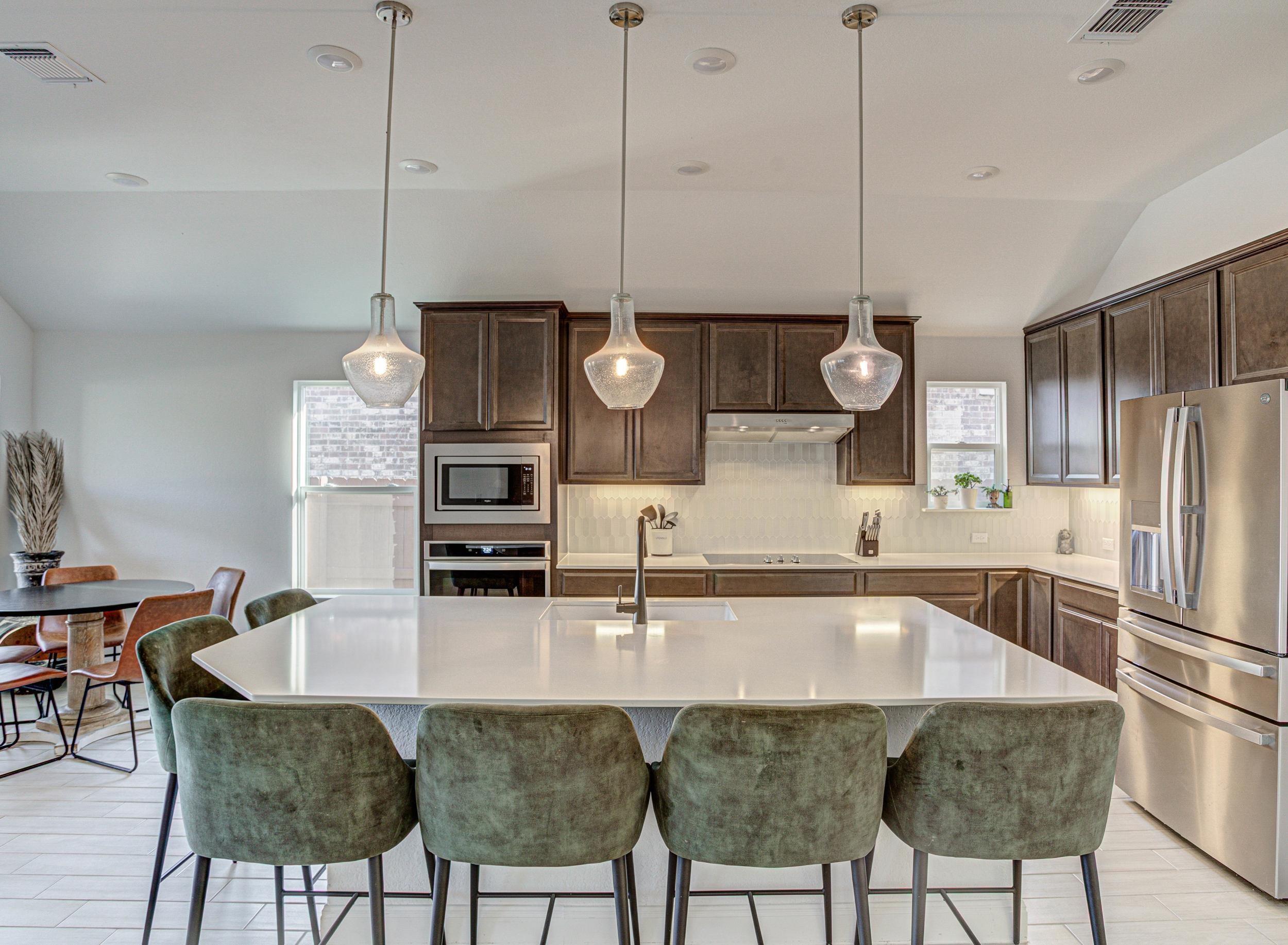 149 Slenderleaf Drive Marble Falls, TX 78654 - Photo 3 of 30 a kitchen with stainless steel appliances granite countertop a sink a stove and a refrigerator