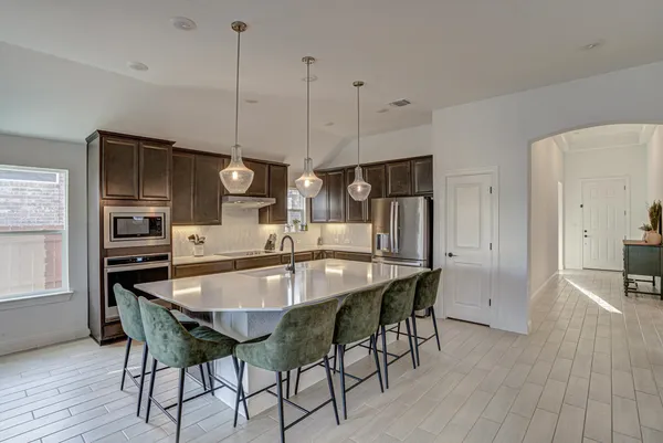 a dining area with furniture and wooden floor