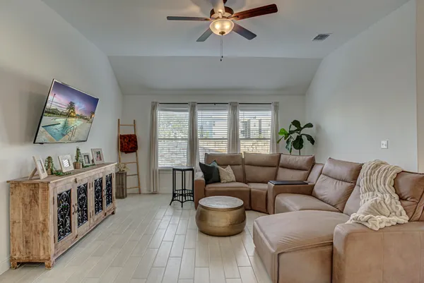 a living room with furniture and a flat screen tv