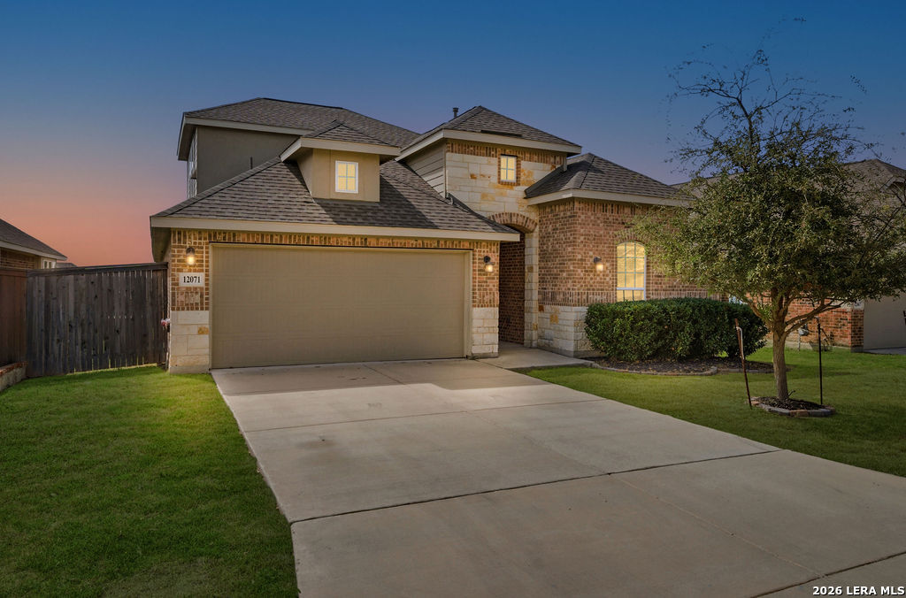 a front view of a house with a yard and garage