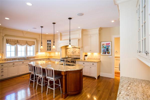 56 Windsor Road Wellesley, MA 02481 - Photo 11 of 24 a kitchen with a stove a sink and white cabinets with wooden floor