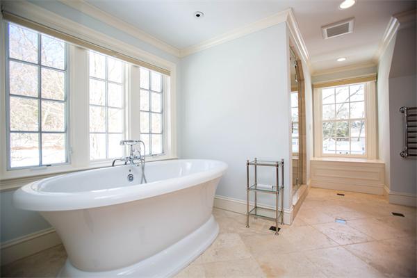 56 Windsor Road Wellesley, MA 02481 - Photo 20 of 24 a white bath tub sitting in a bathroom next to a window