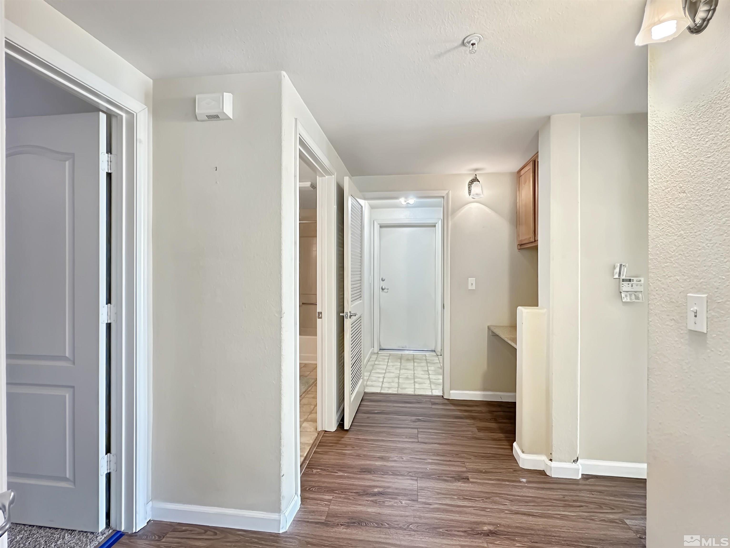 9050 Double R Boulevard, Unit 311 Reno, NV 89521 - Photo 14 of 37 a view of a hallway with wooden floor
