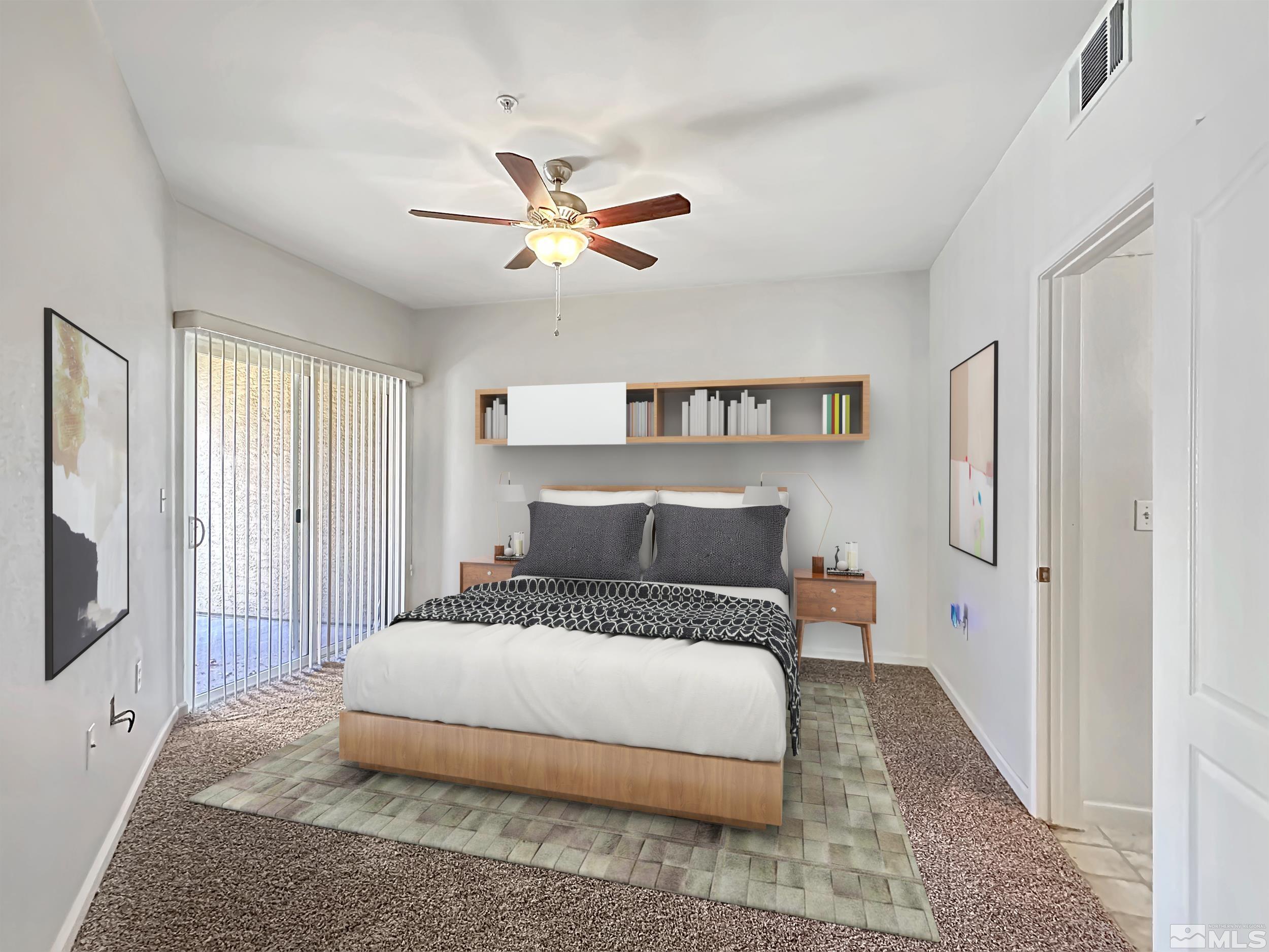 9050 Double R Boulevard, Unit 311 Reno, NV 89521 - Photo 15 of 37 a bedroom with a large bed and a chandelier