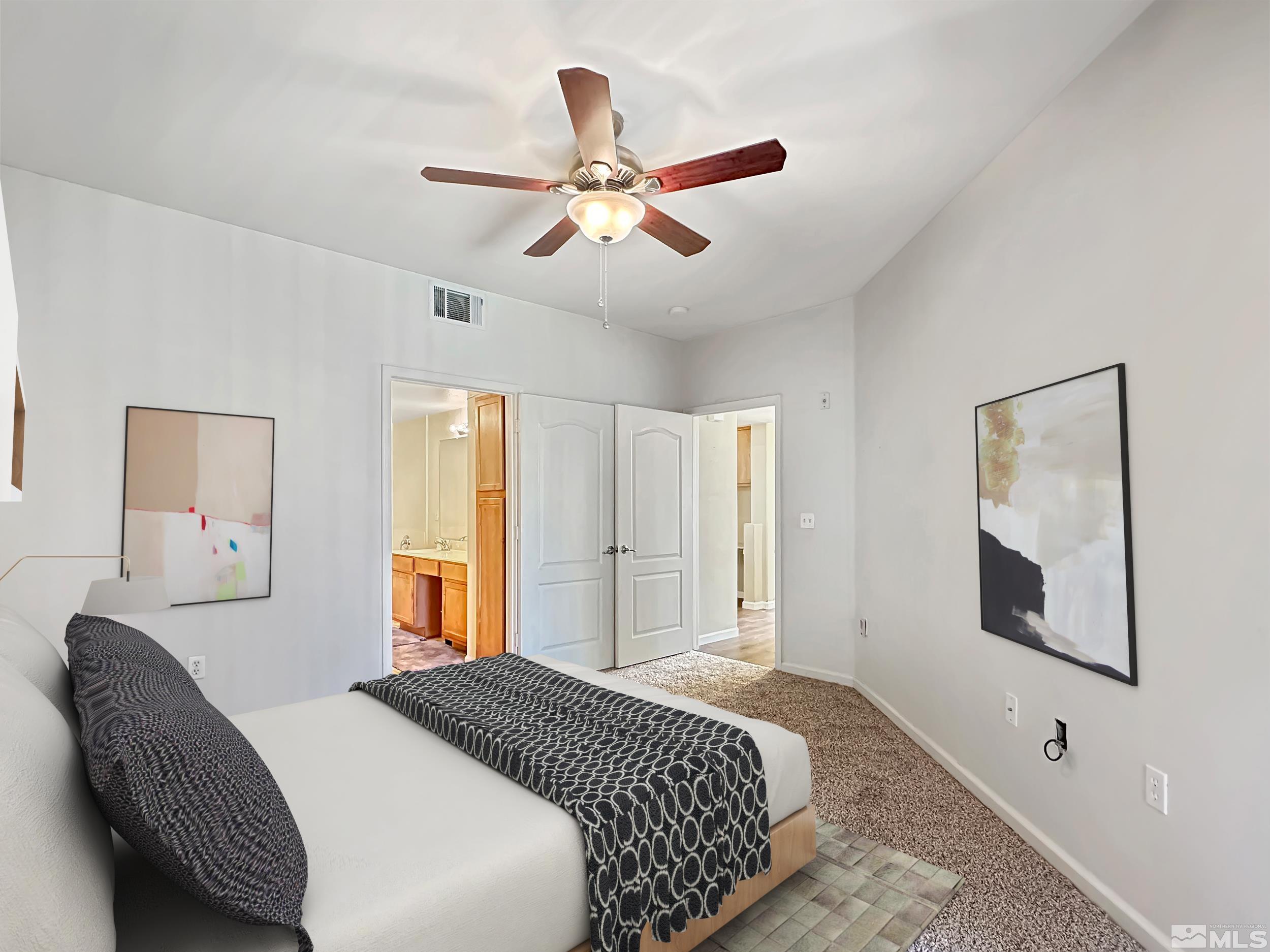 9050 Double R Boulevard, Unit 311 Reno, NV 89521 - Photo 16 of 37 a bedroom with a large bed and a window