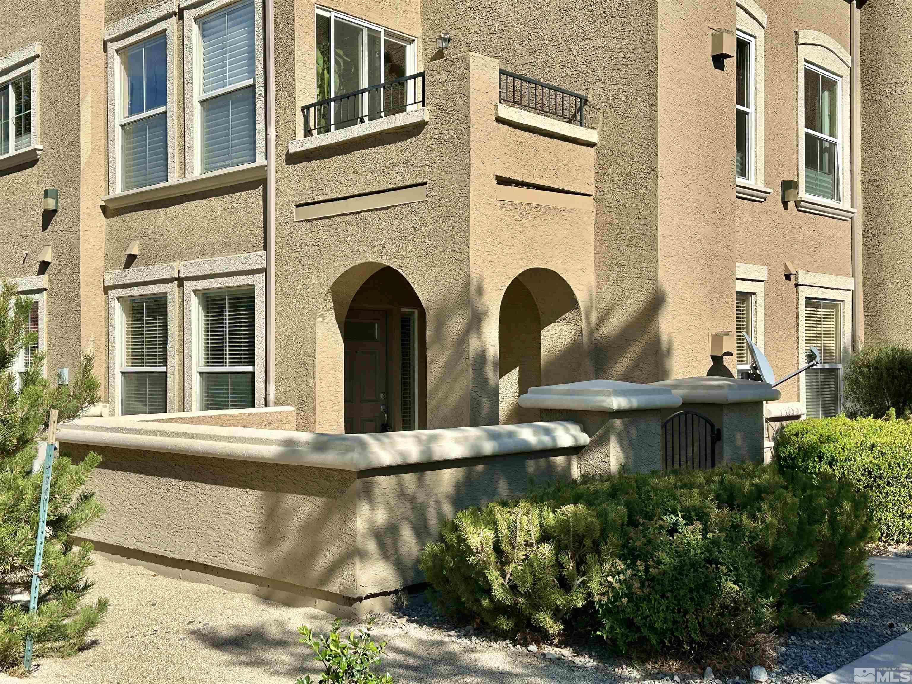 9050 Double R Boulevard, Unit 311 Reno, NV 89521 - Photo 3 of 37 a view of a brick house with windows and plants