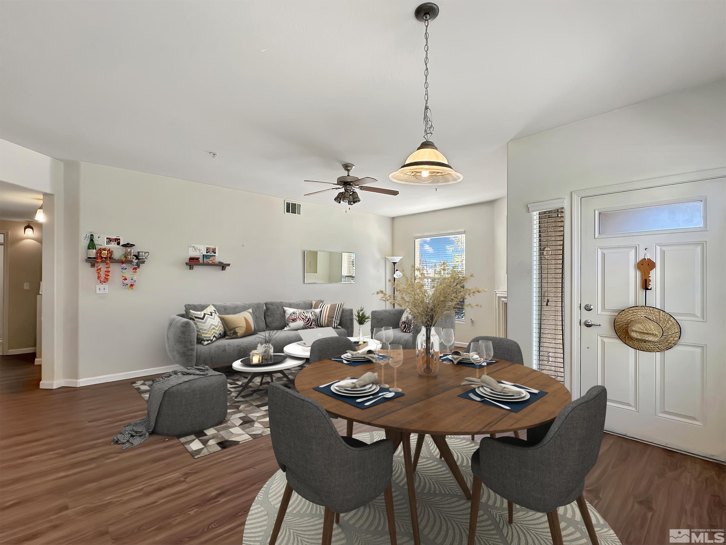 9050 Double R Boulevard, Unit 311 Reno, NV 89521 - Photo 7 of 37 a view of a dining room with furniture wooden floor and chandelier