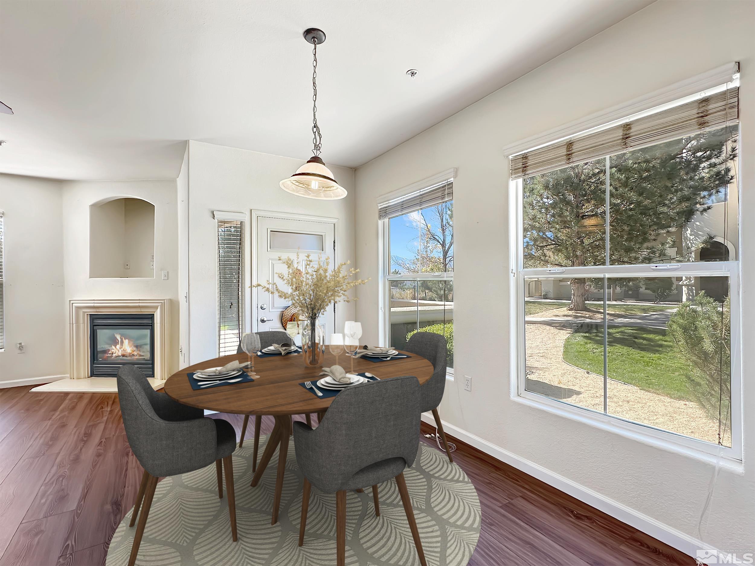 9050 Double R Boulevard, Unit 311 Reno, NV 89521 - Photo 10 of 37 a view of a dining room with furniture window and wooden floor