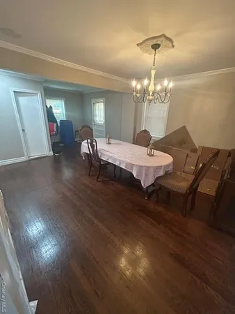 a dining room with furniture and chandelier