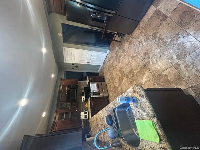 182 Wellington Road Elmont, NY 11003 - Photo 4 of 12 a kitchen with stainless steel appliances granite countertop a sink a stove and a refrigerator