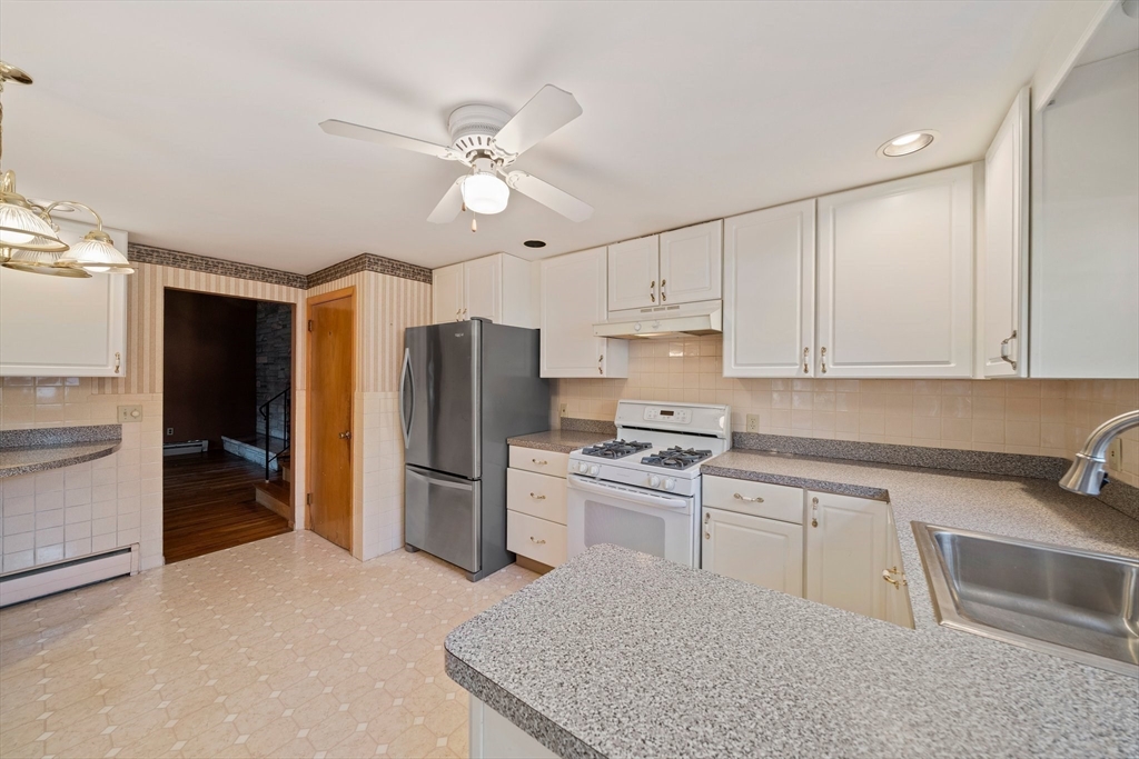 12 Prospect Park Boston, MA 02136 - Photo 11 of 42 a kitchen with a sink stainless steel appliances and cabinets