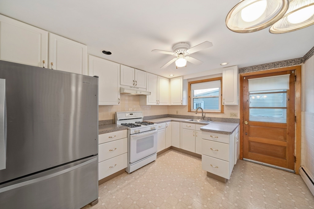 12 Prospect Park Boston, MA 02136 - Photo 12 of 42 a kitchen with granite countertop a refrigerator a sink a stove and white cabinets