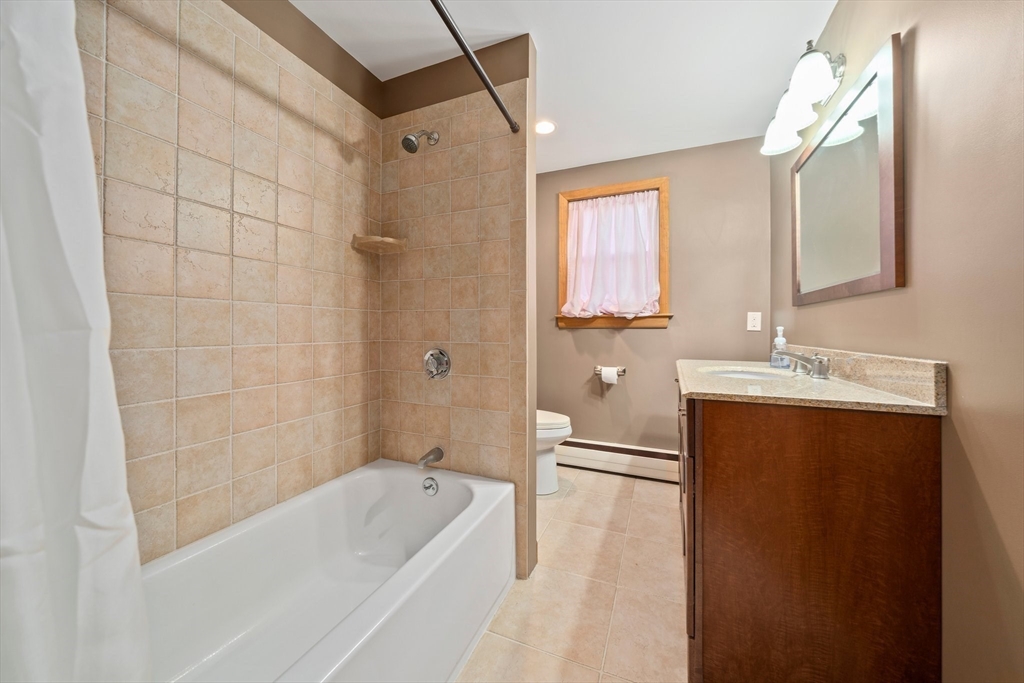 12 Prospect Park Boston, MA 02136 - Photo 18 of 42 a bathroom with a tub a sink and a large mirror