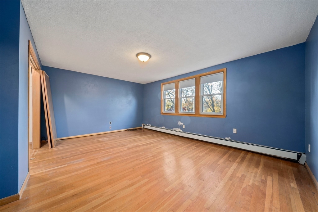 12 Prospect Park Boston, MA 02136 - Photo 19 of 42 a view of an empty room with a window and wooden floor