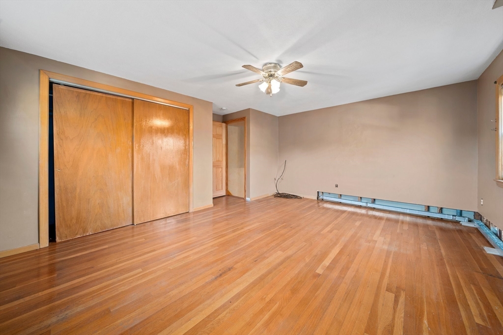 12 Prospect Park Boston, MA 02136 - Photo 23 of 42 an empty room with wooden floor fan and windows