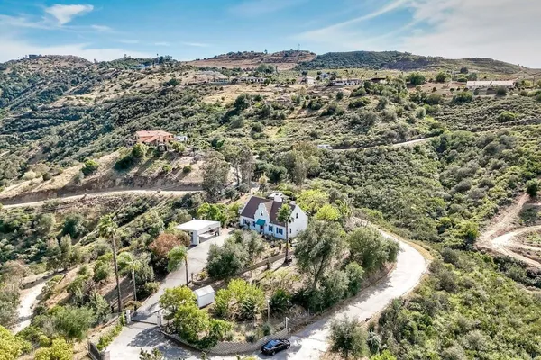 an aerial view of a house with swimming pool and sitting area
