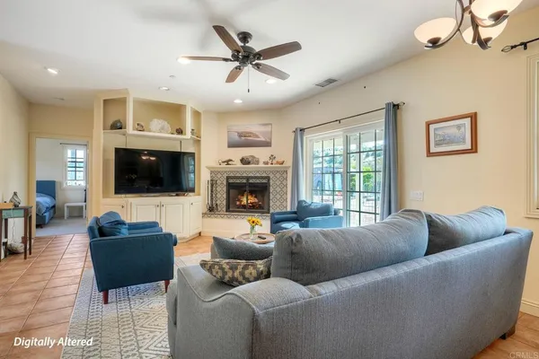 a living room with furniture a flat screen tv and a fireplace