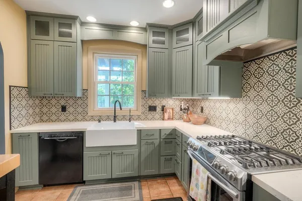 a kitchen with a sink stove and cabinets