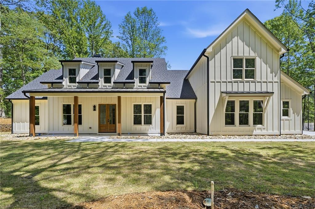 2610 Lower Bethany Road Ball Ground, GA 30107 - Photo 3 of 76 a front view of a house with a garden