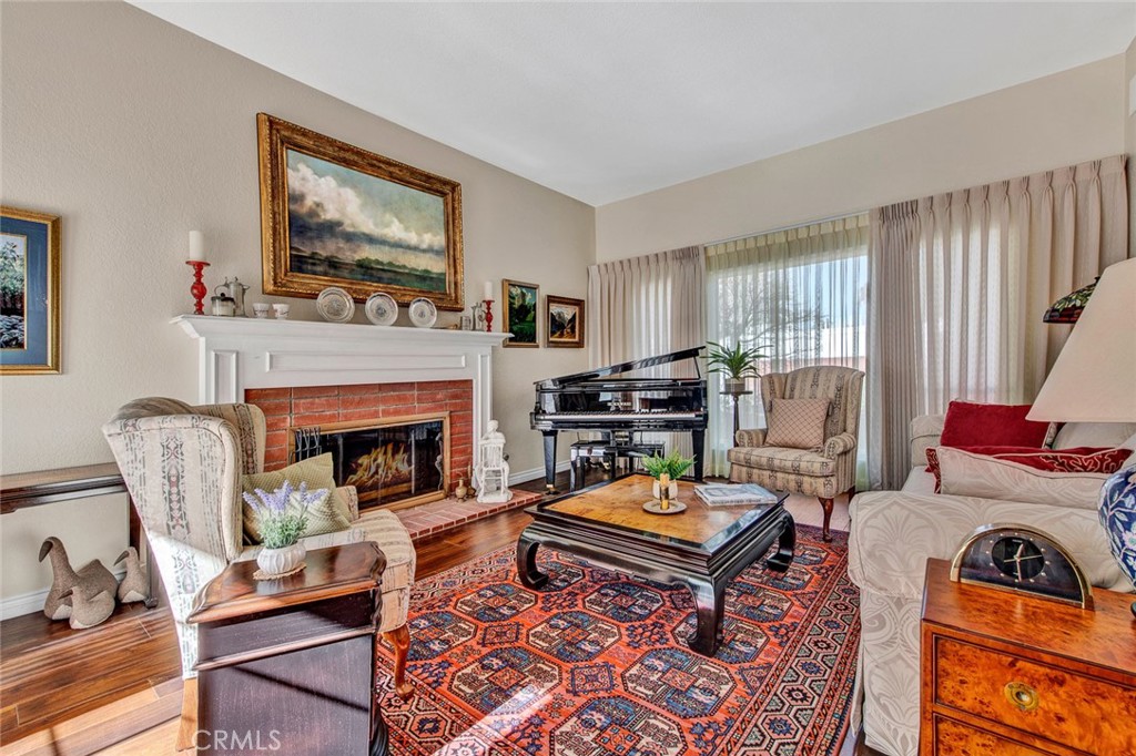 7214 East Wrangler Circle Orange, CA 92869 - Photo 11 of 69 a living room with furniture a flat screen tv and a fireplace