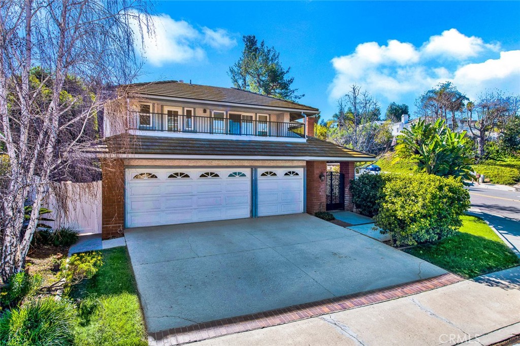 7214 East Wrangler Circle Orange, CA 92869 - Photo 2 of 69 a view of a house with a yard and garden