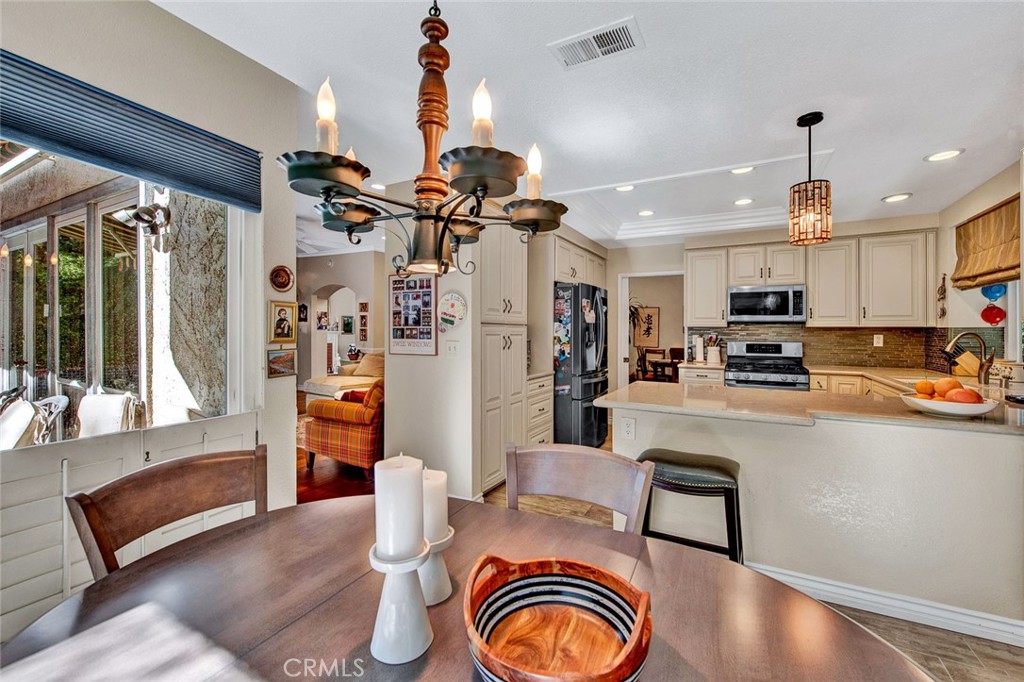 7214 East Wrangler Circle Orange, CA 92869 - Photo 23 of 69 a living room with stainless steel appliances furniture a rug kitchen view and a chandelier